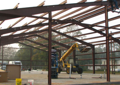 Close-up of a large outdoor metal structure being erected for a commercial building.